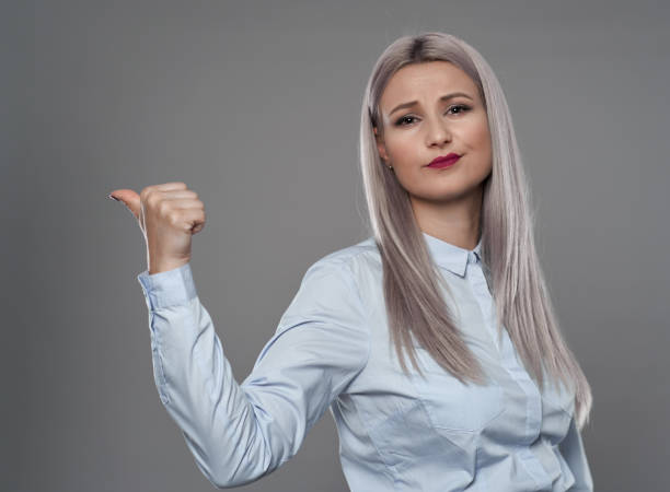 istock Businesswoman indicating side of the image 1287636453