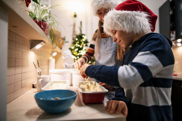 istock Brother and sister making Christmas cake 1287636639