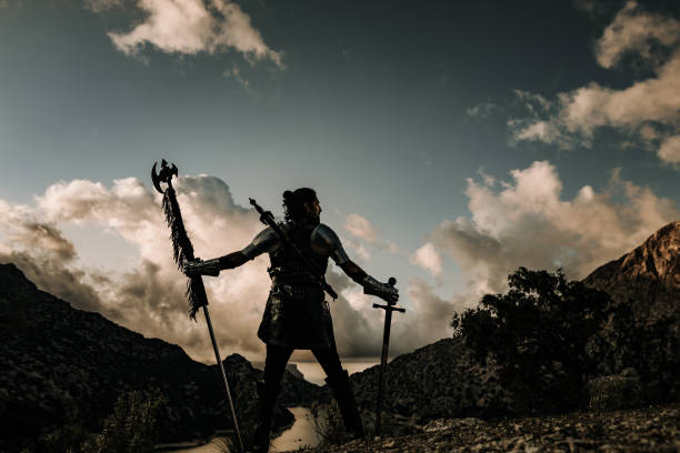 海と素晴らしい風景の前でガードを保つ中世の戦士のシルエット - warrior men horizontal selective focus ストックフォトと画像