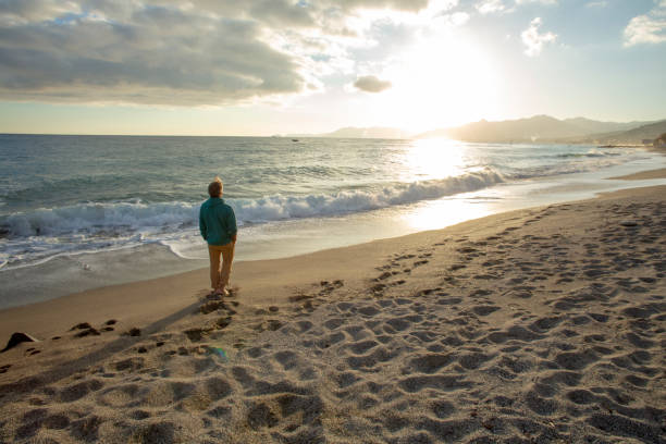 istock Man relaxes on sandy beach in the morning 1287636829