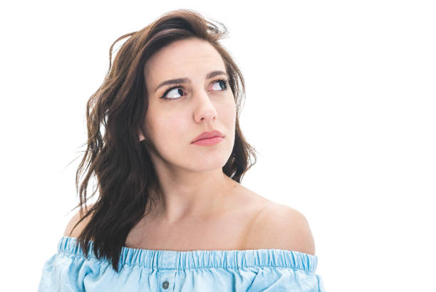 istock Young woman looking up to blank space - copyspace, isolated on white background. Thinking beautiful girl. Close-up 1287636914