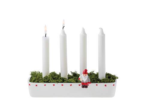 Close up view of traditional advent candlestick with one lighted candle  symbolizing second advent isolated  on white background.