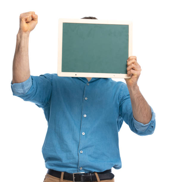 istock handsome casual man hiding behind a board 1287638673