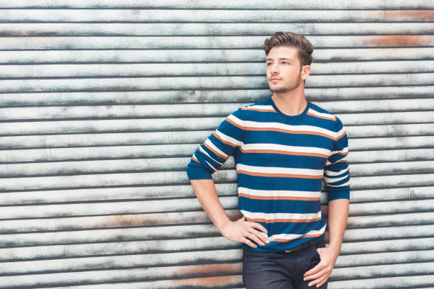istock Beautiful man posing, handsome guy with colorful sweatshirt 1287638999