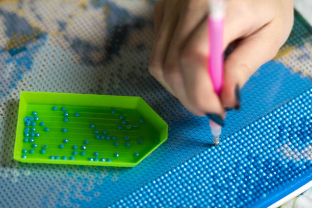 istock Collecting diamond embroidery, diamond mosaic. Colored crystals. Tools. Close up 1287639948