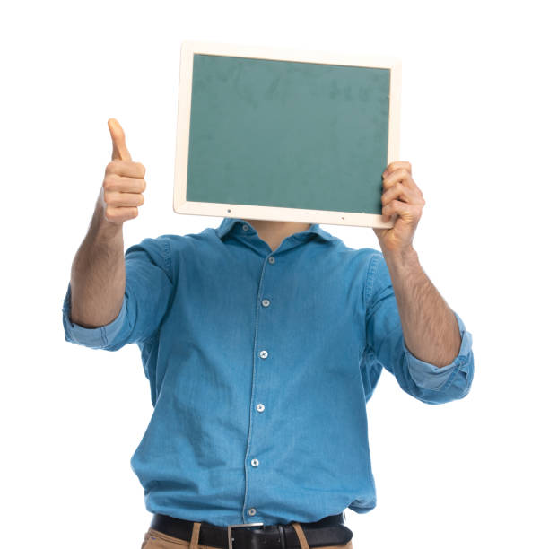 istock casual man hiding behind a board and giving a thumbs up 1287640245