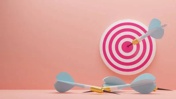 Photo of 3D illustration. Blue Arrow hitting the center of target on the wall. Arrows that missed the target lie on the floor.Success business concept . Render