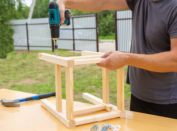 istock assembling a wooden stool with an electric screwdriver 1287642676