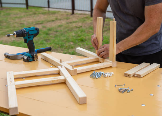 istock assembling a wooden stool with an electric screwdriver 1287642693