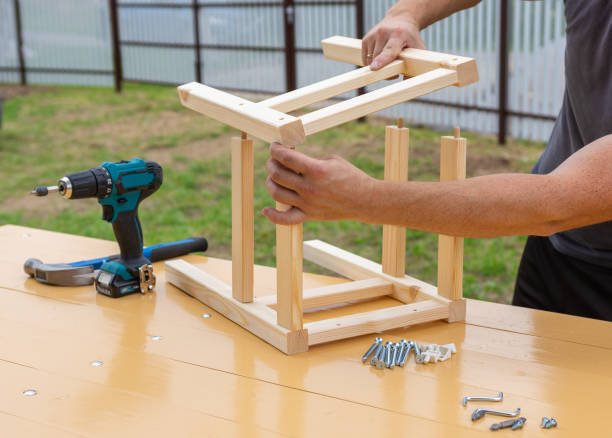 istock assembling a wooden stool with an electric screwdriver 1287642703
