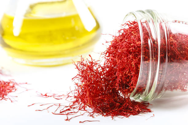 istock Dried saffron threads in a glass bottle and oil extract on a white background. 1287643305