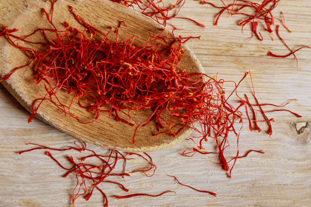 istock Dry saffron threads in a wooden spoon on a wooden background. 1287643334