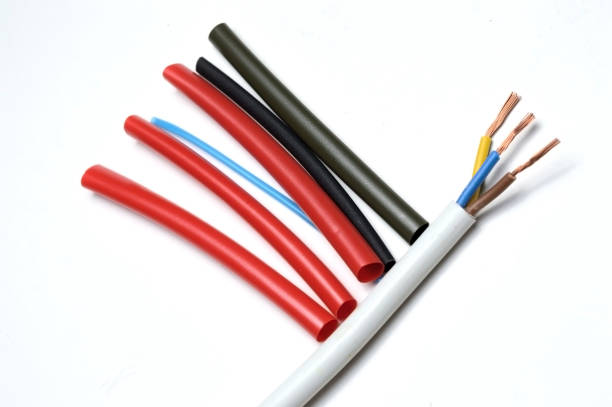 istock heat shrink tubing and a three-core stripped wire on a white background. 1287644388