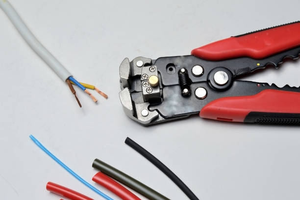 istock wire stripper, shielded three-core wire and heat shrink tubing on a white background. close-up 1287644432