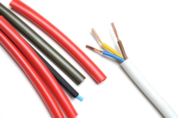 istock heat shrink tubing and a three-core stripped wire on a white background. 1287644474