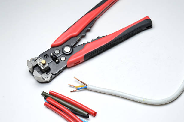istock wire stripper, shielded three-core wire and heat shrink tubing on a white background. close-up 1287644530
