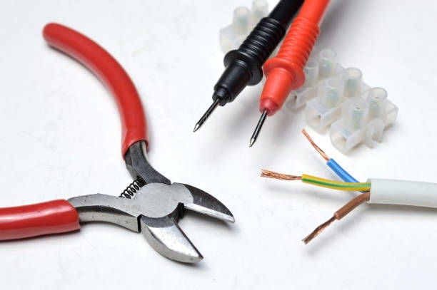 istock cutters, electric wire, tester probes and terminal block on a white background close-up. 1287644591