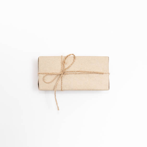 istock Gift in craft paper on a white background. 1287645715