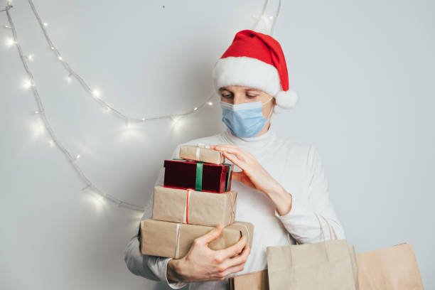 istock Christmas, New Year delivery, man courier in Santa hat, mask 1287650179