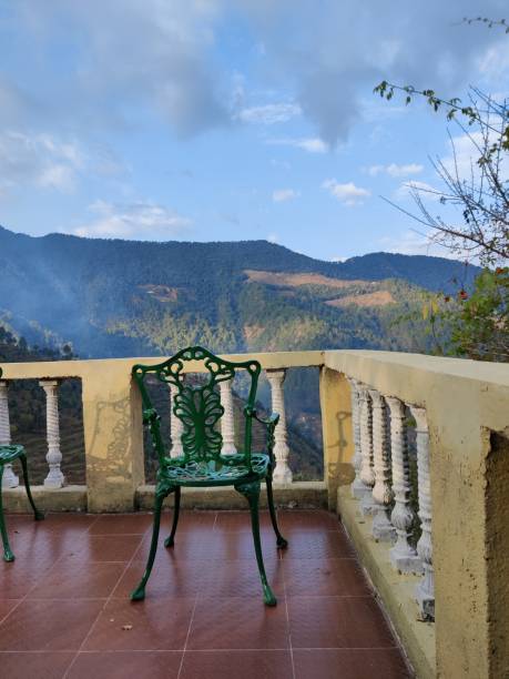 istock Empty chair in the balcony against scenic landscape 1287651649
