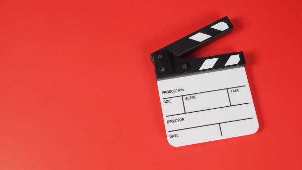 istock small Clapper board  in studio shooting .It is use in video production and movie industry on red background. 1287652099