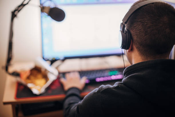 istock Male gamer playing video games on computer 1287653502