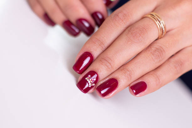 istock Female hands with red manicure 1287654313