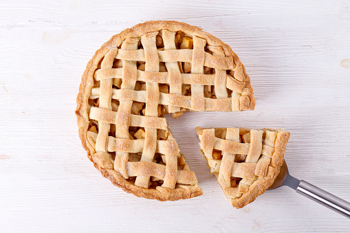 Traditional American Thanks Giving lattice pie isolated on white background. Homemade fruit tart baked to golden crust. Close up, copy space, top view.