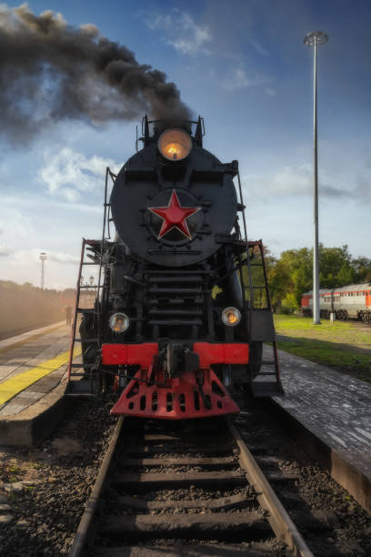 istock Old retro vintage steam train on platform station 1287655073