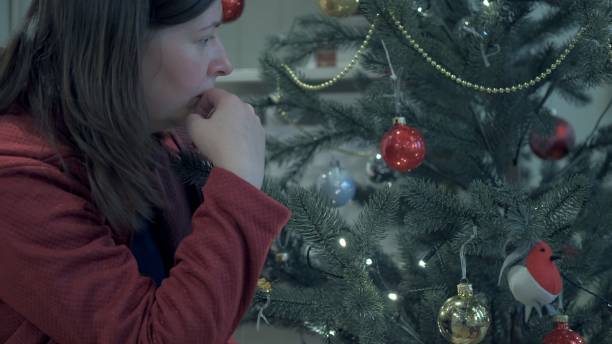 istock Lady puts gifts under tree. Concept of holiday and hearth 1287655821