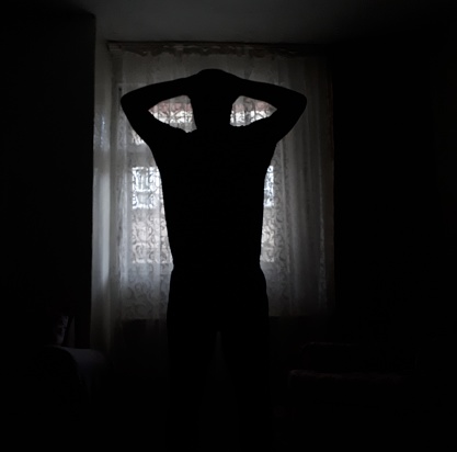 Man silhouette in front of the window