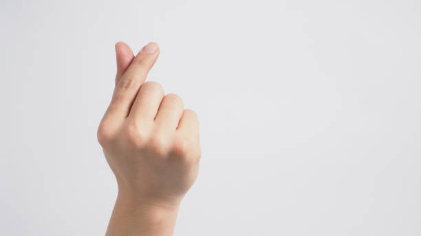 istock Male model is doing mini heart hand sign with backhand on white background. 1287656049
