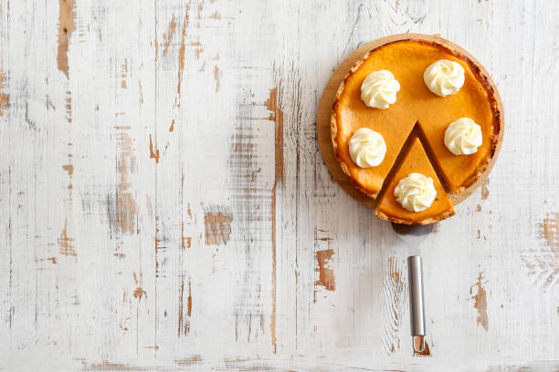 Pumpkin pie made of organic ingredients. Traditional thanksgiving food concept. Orange delicious homemade pumpkin pie with crust on grunged wood textured table. .Top view, close up, copy space, background. carrot cake day stock pictures, royalty-free photos & images