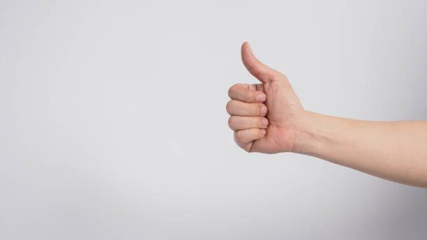 istock Right hand is doing thumbs up or Like sign on white background. 1287656072