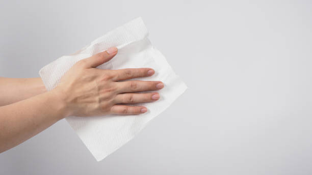 istock Male model is dry hands thoroughly with tissue paper on white background. 1287656155