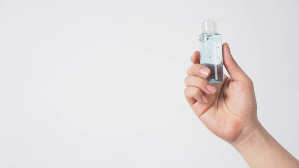 istock Hand is holding alcohol hand gel on white background. 1287656242
