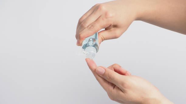istock Hands is squeezeing alcohol hand gel on white background. 1287656265