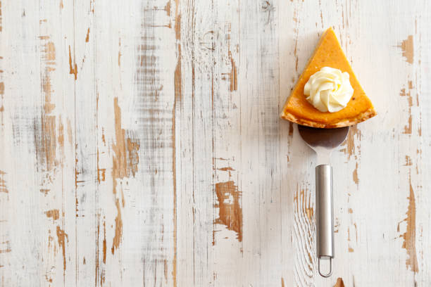 Pumpkin pie made of organic ingredients. Traditional thanksgiving food concept. Orange delicious homemade pumpkin pie with crust on grunged wood textured table. .Top view, close up, copy space, background. carrot cake day stock pictures, royalty-free photos & images