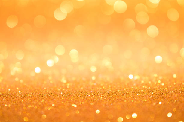 istock Beautiful gold abstract background with bokeh defocused lights 1287657001