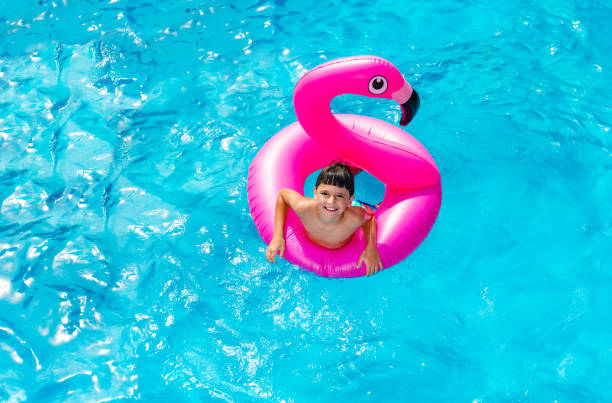 istock Boy swim in inflatable flamingo view from above 1287657143