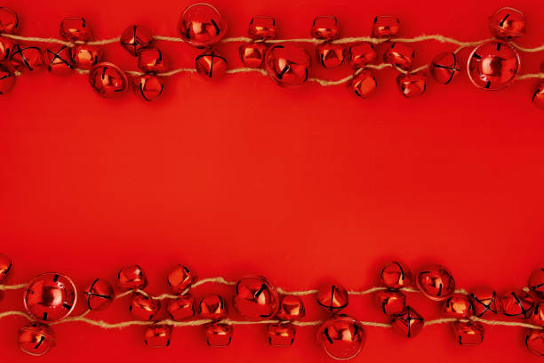 istock flat lay with christmas jingle bells on red background 1287657405
