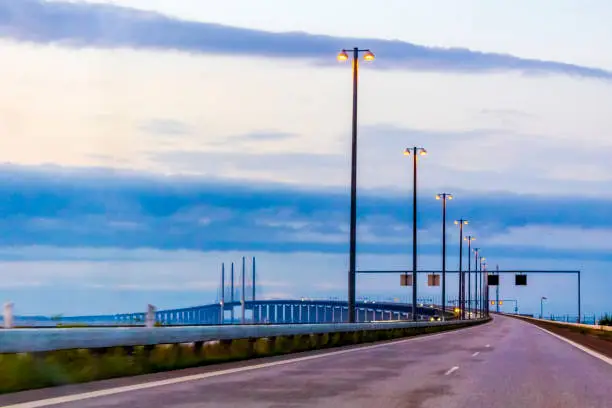 Driving over the Øresundsbron Bridge at beautiful sunrise in Malmo, Sweden.