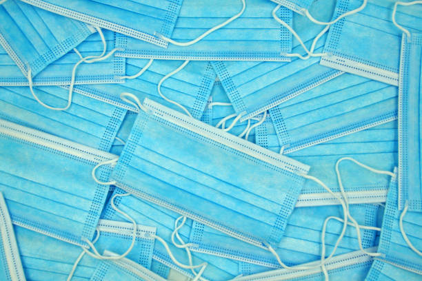 istock Pile of blue mouth nose masks 1287659657