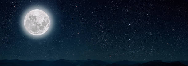 istock mountain. backgrounds night sky with stars and moon and clouds. 1287664294