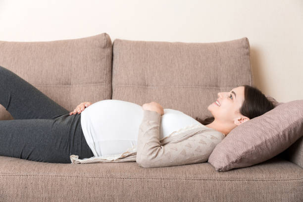 istock Pregnant woman relaxing at home on sofa 1287665764