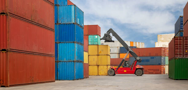 istock Crane lifting up container in a port. 1287666519
