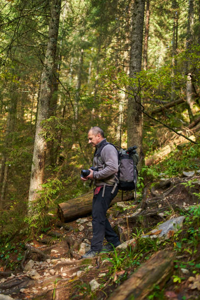 istock Professional nature photographer hiking 1287667557