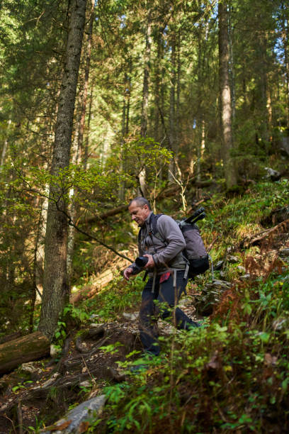 istock Professional nature photographer hiking 1287667561