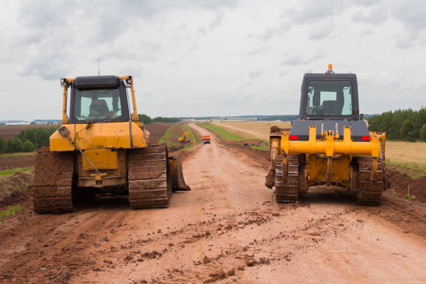 istock Bulldozer during road construction. Construction machinery. Earth moving by a bulldozer in the construction of a road. Excavator on a construction site of a road 1287669586