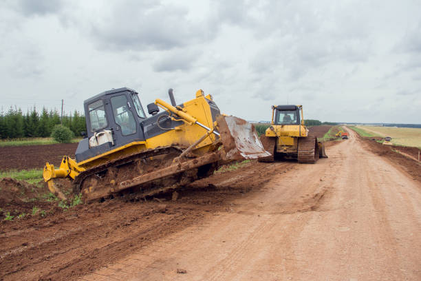 istock Bulldozer during road construction. Construction machinery. Earth moving by a bulldozer in the construction of a road. Excavator on a construction site of a road 1287669593